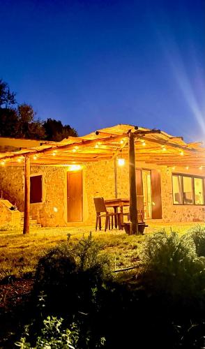 a picnic table in front of a house at night at Le Tre Aie in San Giovanni a Piro
