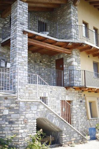 a stone building with stairs and balconies on it at VistaStelle in Aosta