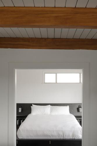 a bedroom with a white bed and a window at Hollywood Hills Hotel in Los Angeles