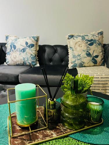 a living room with a table with vases and a couch at Blyde Lagoon in Pretoria