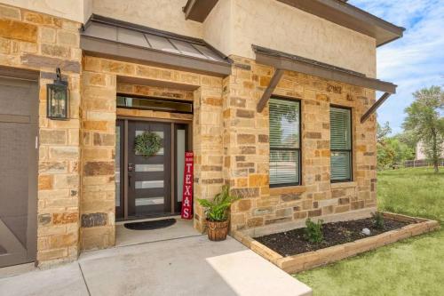 a brick house with a front door and a garage at The Riverscape at Gruene in New Braunfels