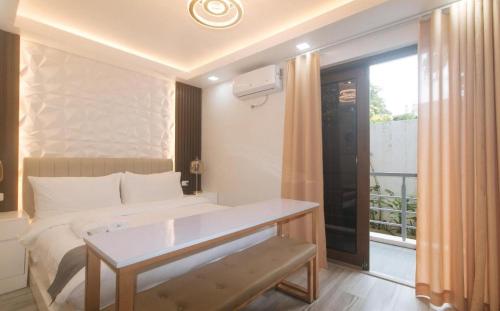 a hotel room with a bed and a window at Grospe Resort Boracay in Boracay