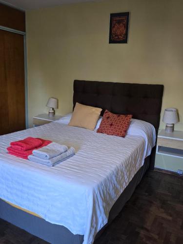 a bedroom with a bed with towels on it at En la cañada cerca de todo in Córdoba