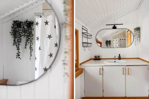 a bathroom with a sink and a mirror at 2544-Nexo-Skovsangervej-29 in Neksø