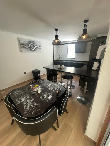 a room with a table and chairs and a piano at AH Hotel in Antofagasta