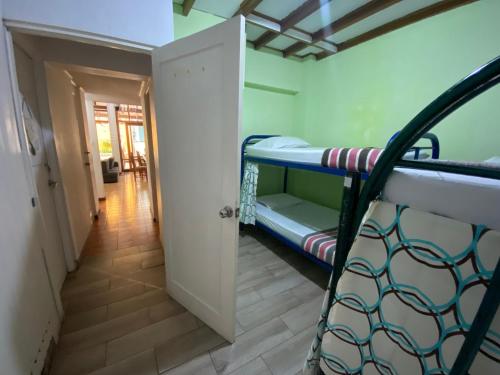a room with a bunk bed and a hallway at Gaudy's Hotel in San José