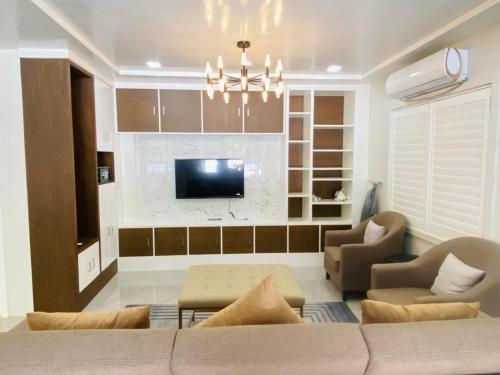a living room with a couch and a tv at Grospe Resort Boracay in Boracay