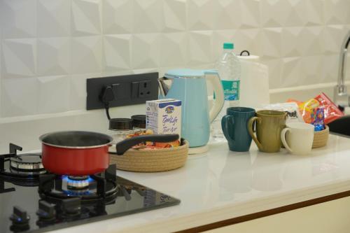 a kitchen counter with a pot on a stove at Contemporary Serviced Apartment in Kolencherry in Kadayirippu