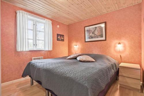 a bedroom with a bed and a window at 3517-Nexo-Turistvej-47-B in Neksø