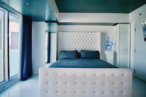 a bedroom with a large white bed in a room at High-Rise Two-Bedroom Condo with Panoramic City Views in Las Vegas