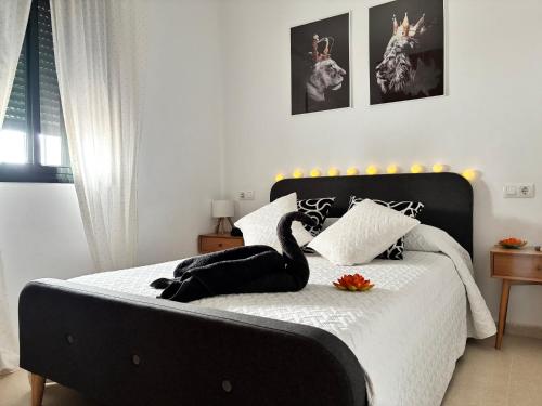 a bedroom with a bed with a swan on it at Casa Azacanes in Sanlúcar de Barrameda