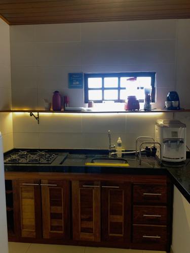 a kitchen with a sink and a counter top at 07 Apartamento com vista para a montanha in São Sebastião