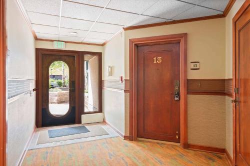 an empty hallway with a wooden door in a building at Village Hall 13 by East West Hospitality in Beaver Creek