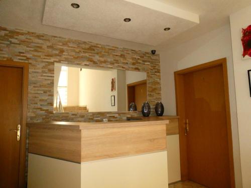 a bathroom with a mirror and a brick wall at Apartments In Amor in Ulcinj