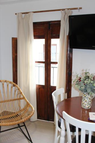 a dining room with a table and a television at Gaia Rural Cazorla in Cazorla