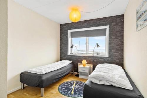 a bedroom with two beds and a window at 5598-Allinge-Ndr-Strandvej-4-A-1-th in Allinge