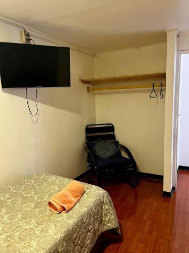 a bedroom with a bed and a flat screen tv at Bocamar Aparthotel in Viña del Mar
