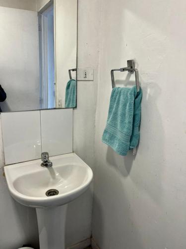 a white bathroom with a sink and a mirror at Bocamar Aparthotel in Viña del Mar