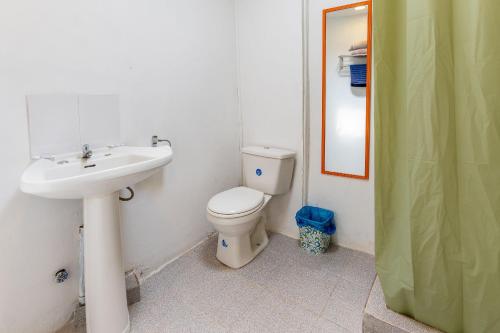 a bathroom with a white toilet and a sink at Bocamar Aparthotel in Viña del Mar