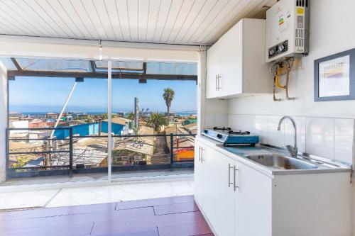 a kitchen with a view of the ocean at Bocamar Aparthotel in Viña del Mar