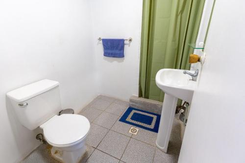 a bathroom with a toilet and a sink at Bocamar Aparthotel in Viña del Mar