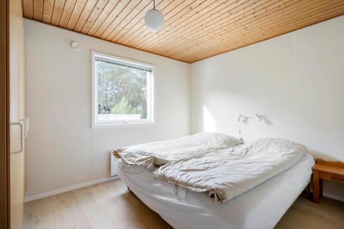 a bedroom with a bed with a wooden ceiling at 2512-Nexo-Rokjinkan-7 in Vester Sømarken