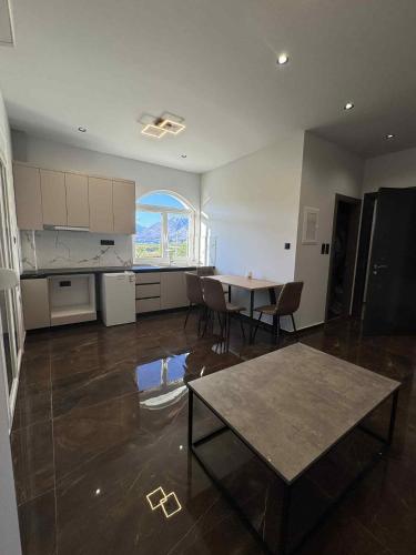 a kitchen and dining room with a table and chairs at Old Castle Location in Gjirokastër
