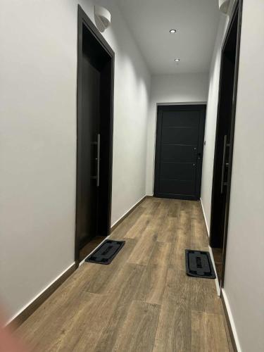an empty room with two doors and a wooden floor at Old Castle Location in Gjirokastër