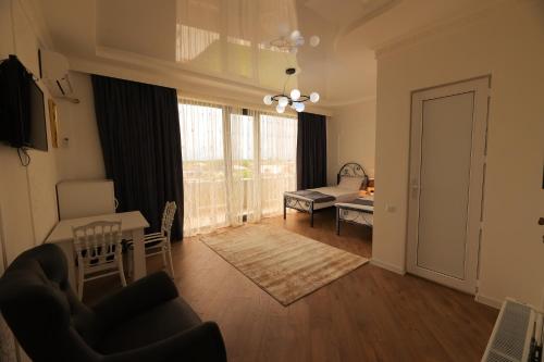 a living room with a couch and a table at Hotel Harmony Premium in Kutaisi