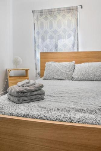 a bedroom with a bed with a wooden head board at Avenir Centre Suite - Near NBCC - Large Garden in Moncton