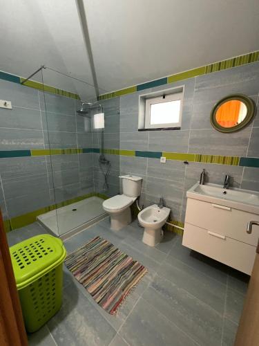 a bathroom with two toilets and a sink at Casa da Armada in Magoito