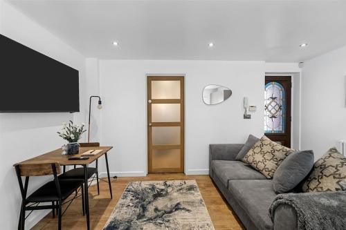 a living room with a couch and a table at 1 Bed Stylish Central Apartment - Barbican Plymouth in Plymouth