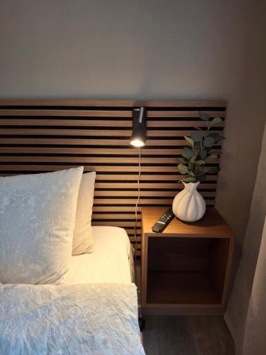 a bedroom with a bed and a vase on a table at Kattugglans Guestroom 2 in Ljungby