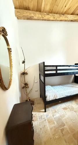 a room with two bunk beds and a mirror at Le Tre Aie in San Giovanni a Piro
