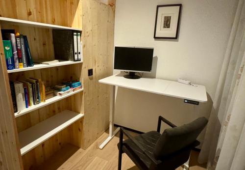 a computer sitting on a desk with a chair at Nature Oasis near Berlin - Peaceful and Modern Stay in Falkensee