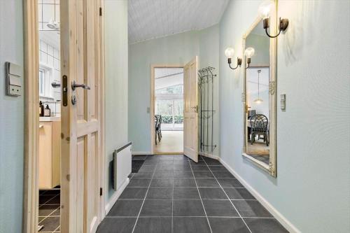 a hallway of a home with a mirror and a door at 4759-Ronne-Stampen-Vej-1-Hus-4 in Rønne
