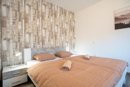 Postel nebo postele na pokoji v ubytování Avanti Apartman - Avanti Garden