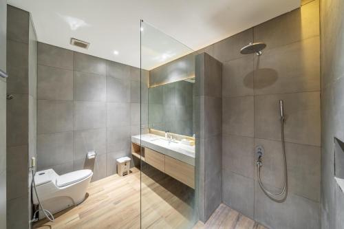 a bathroom with a toilet and a sink and a shower at Villa Nayana In The heart of Semiya in Seminyak
