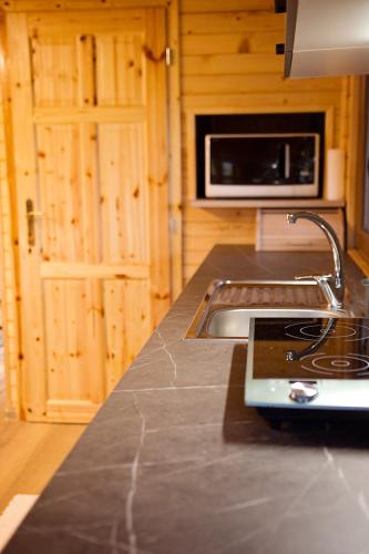 a kitchen with a sink and a counter top at Chalúpka pod brezou in Muráň