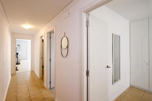 a hallway with white walls and a mirror on the wall at Wake up by the sea in your cozy Denia corner in Denia