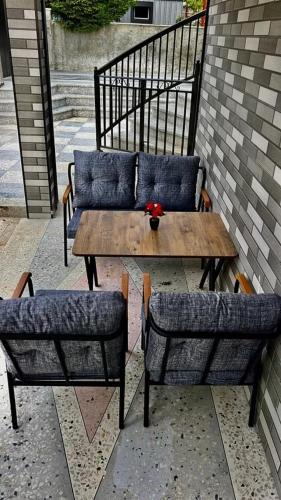a wooden table with two chairs and a couch at Family House with Sea and Mountain View Kobuleti in Kvirike