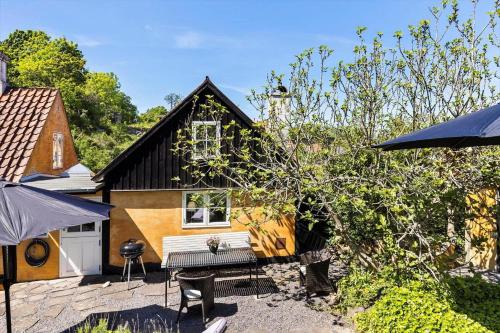 a house with a bench in front of it at 5606-Gudhjem-Holkavej-12 in Gudhjem