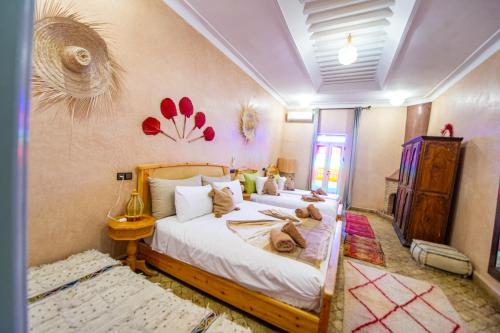 a bedroom with a bed with stuffed animals on it at KOUTOBIA ROYAL in Marrakech