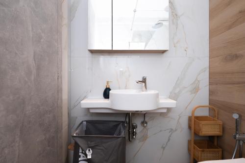 a bathroom with a sink and a mirror at Smiles Apartments With Panoramic View in Zipárion