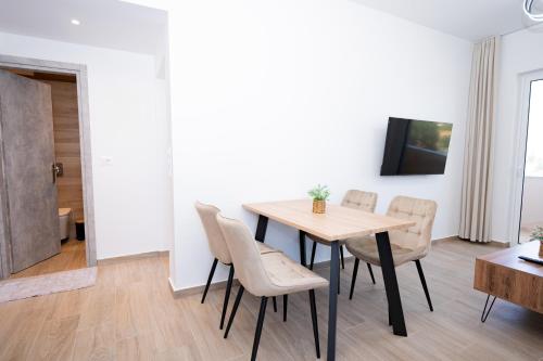 a dining room with a table and chairs at Smiles Apartments With Panoramic View in Zipárion