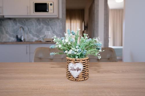 a vase filled with flowers sitting on a table at Smiles Apartments With Panoramic View in Zipárion