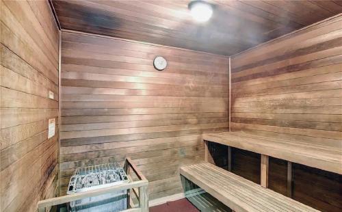 a sauna with wooden walls and a clock on the wall at One-Bedroom Condo with City Views and Resort Amenities in Long Beach
