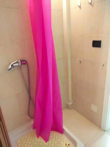 a pink shower curtain in a bathroom with a tub at Dolce Riposo in Trani