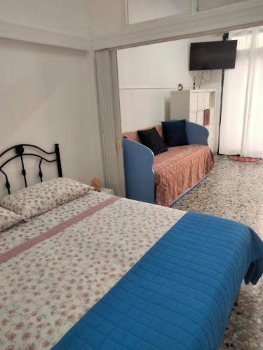 a bedroom with a bed and a couch at Dolce Riposo in Trani