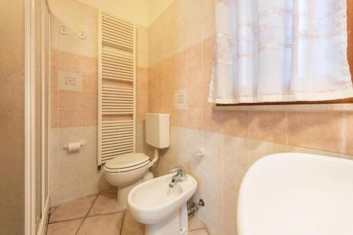 a bathroom with a toilet and a sink at Trento33 in Lazise